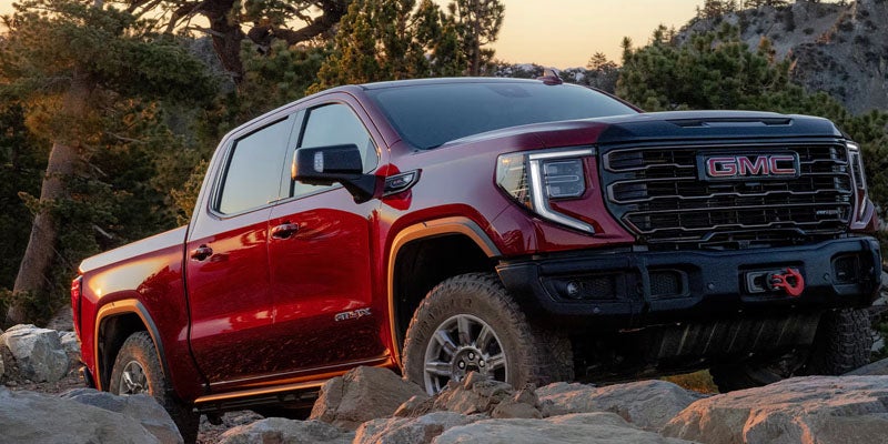 Red GMC Sierra 1500 on cliff