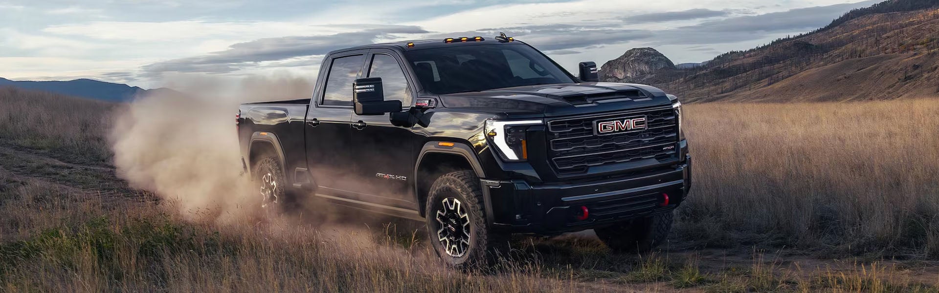 Black GMC Sierra running on field 