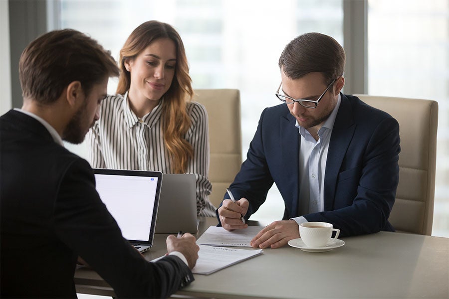 Woman and Man signing documents